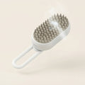 White self-cleaning steam pet brush with mist, cream background
